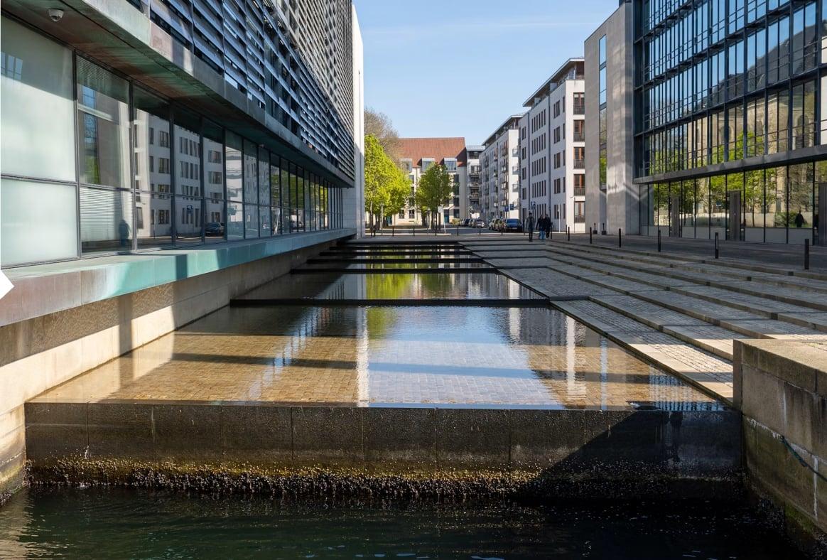 Modern office buildings beside a stepped water channel